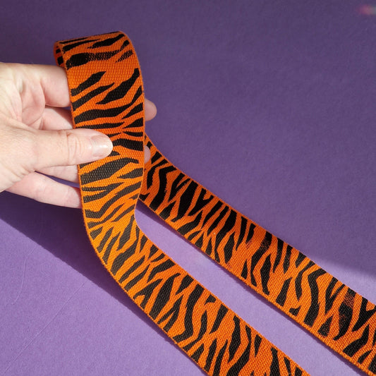 showing webbing with a tiger print black on orange