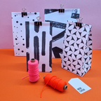 Brush-stroke triangle pattern paired with half-circle and dot pattern gift bags